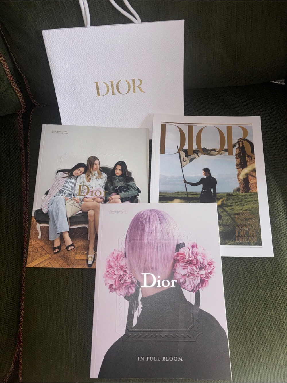 Dior Bundle of three books, shopping bag, and ribbon.